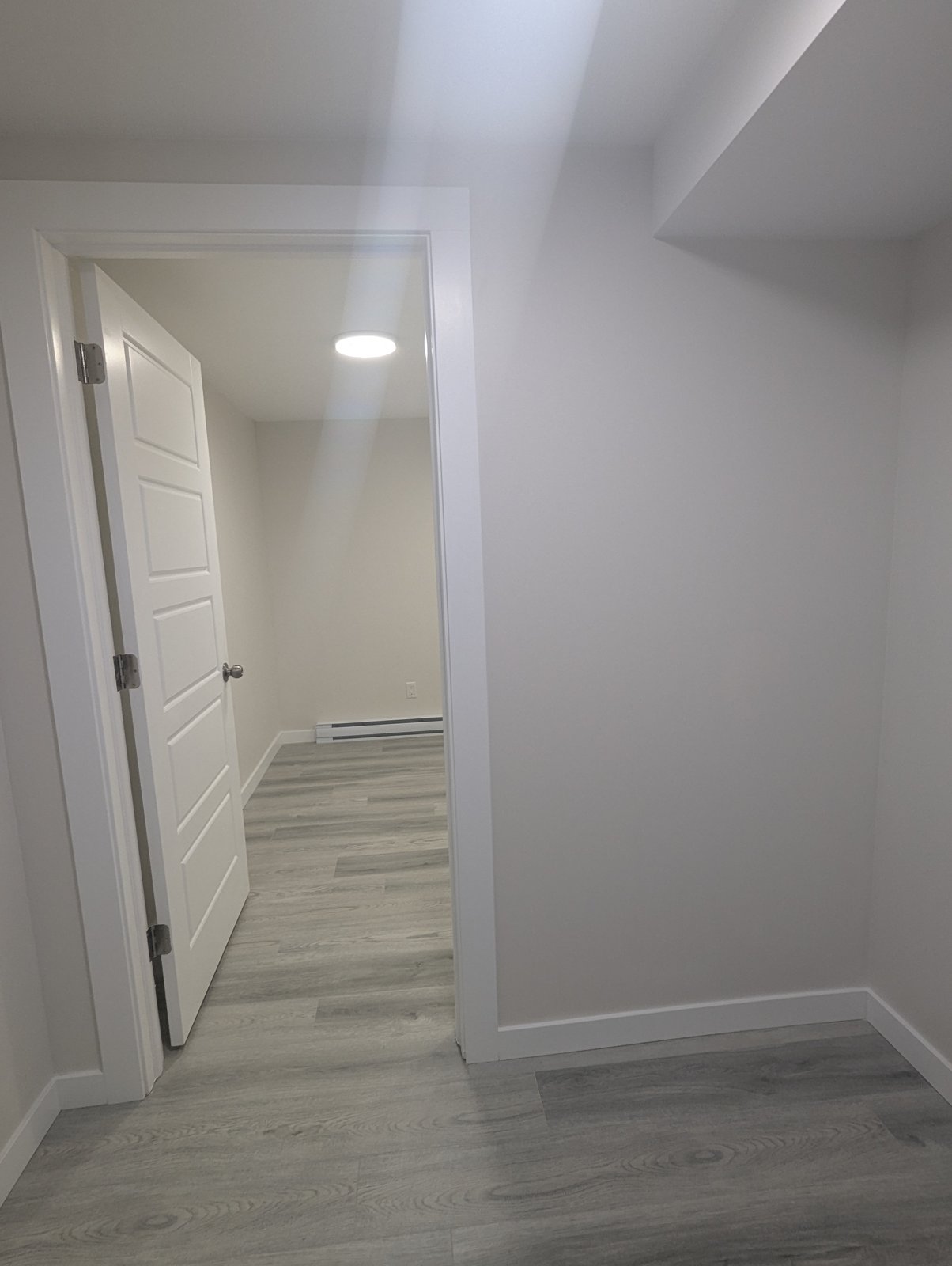 Completed basement hallway with trim and flooring, Dieppe NB