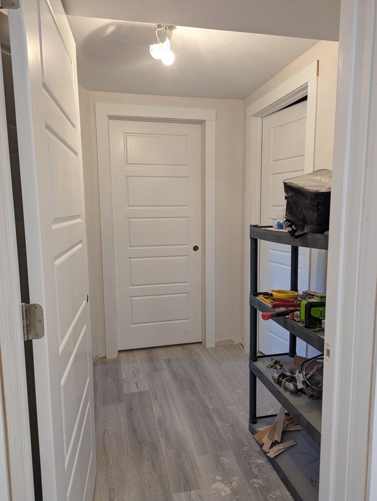 Basement hallway with new flooring and doors installed, Dieppe NB