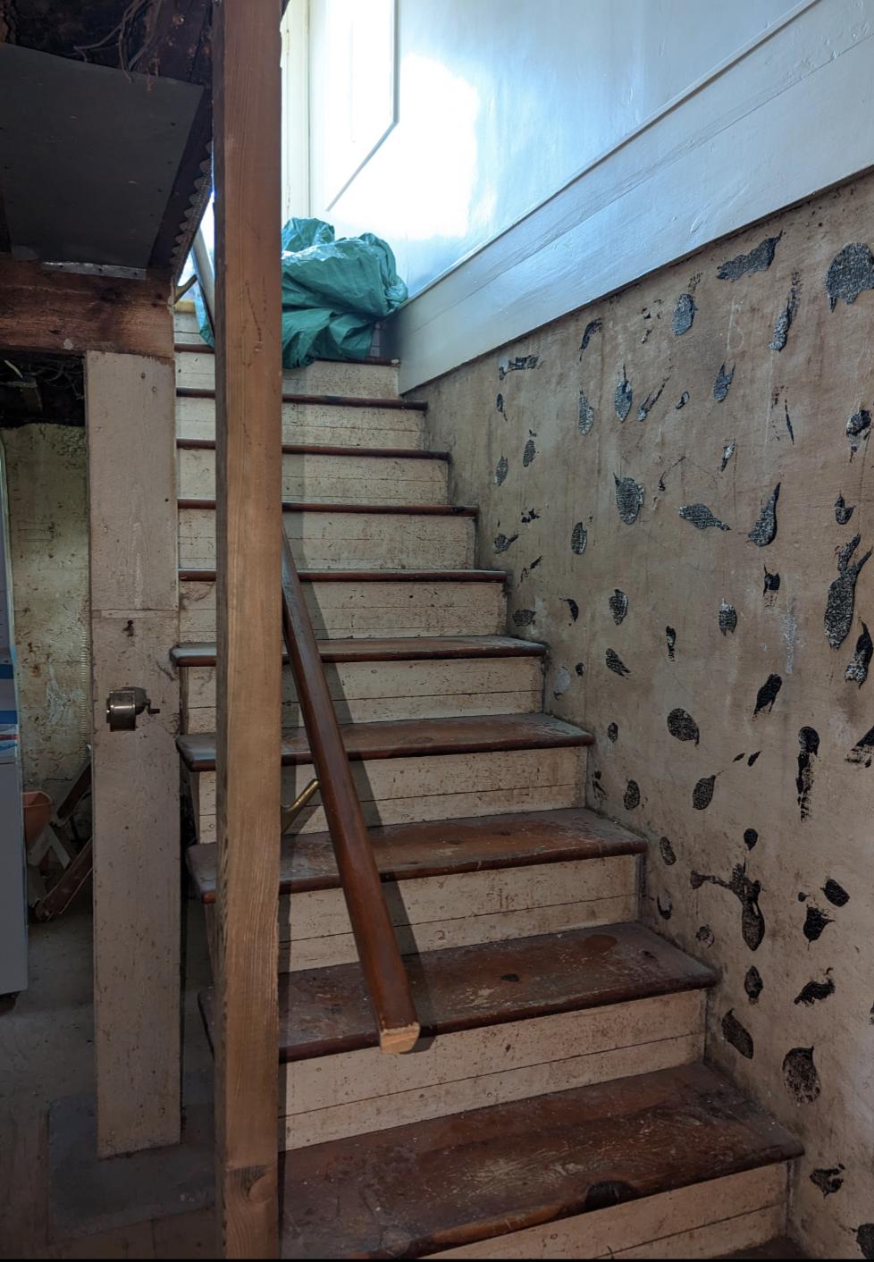 Original basement stairs and damaged foundation wall before renovation, Riverview NB