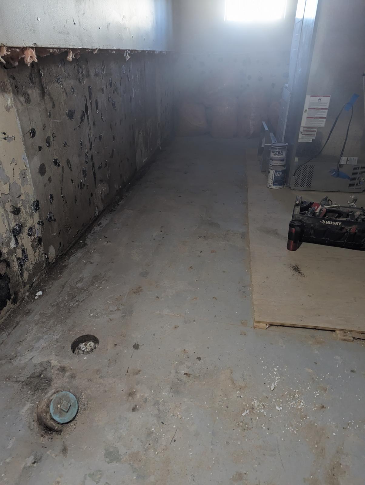 Bare foundation wall with old damp-proofing before new moisture control, Riverview NB