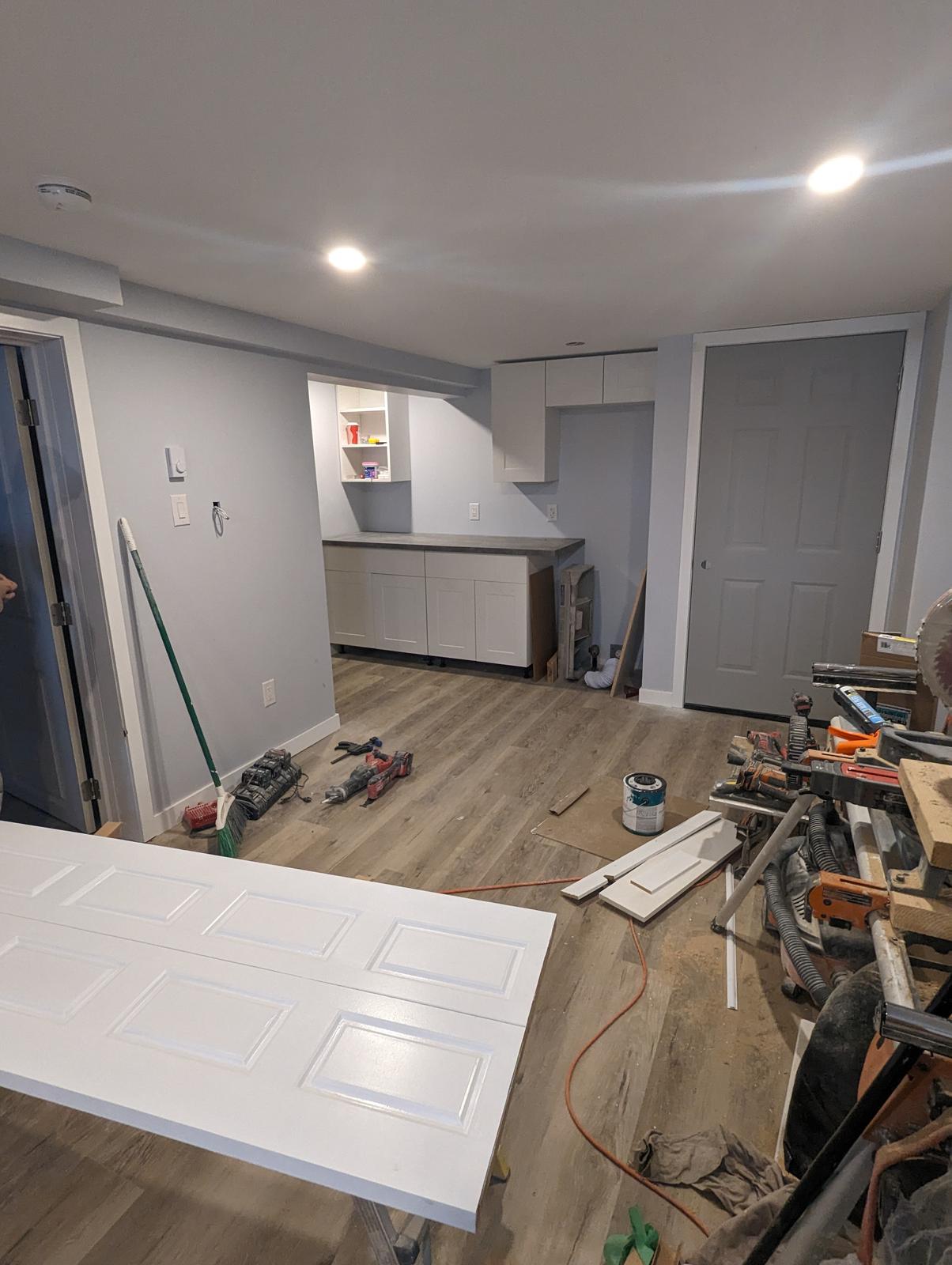 Basement suite kitchenette cabinets and counter being installed, Riverview NB