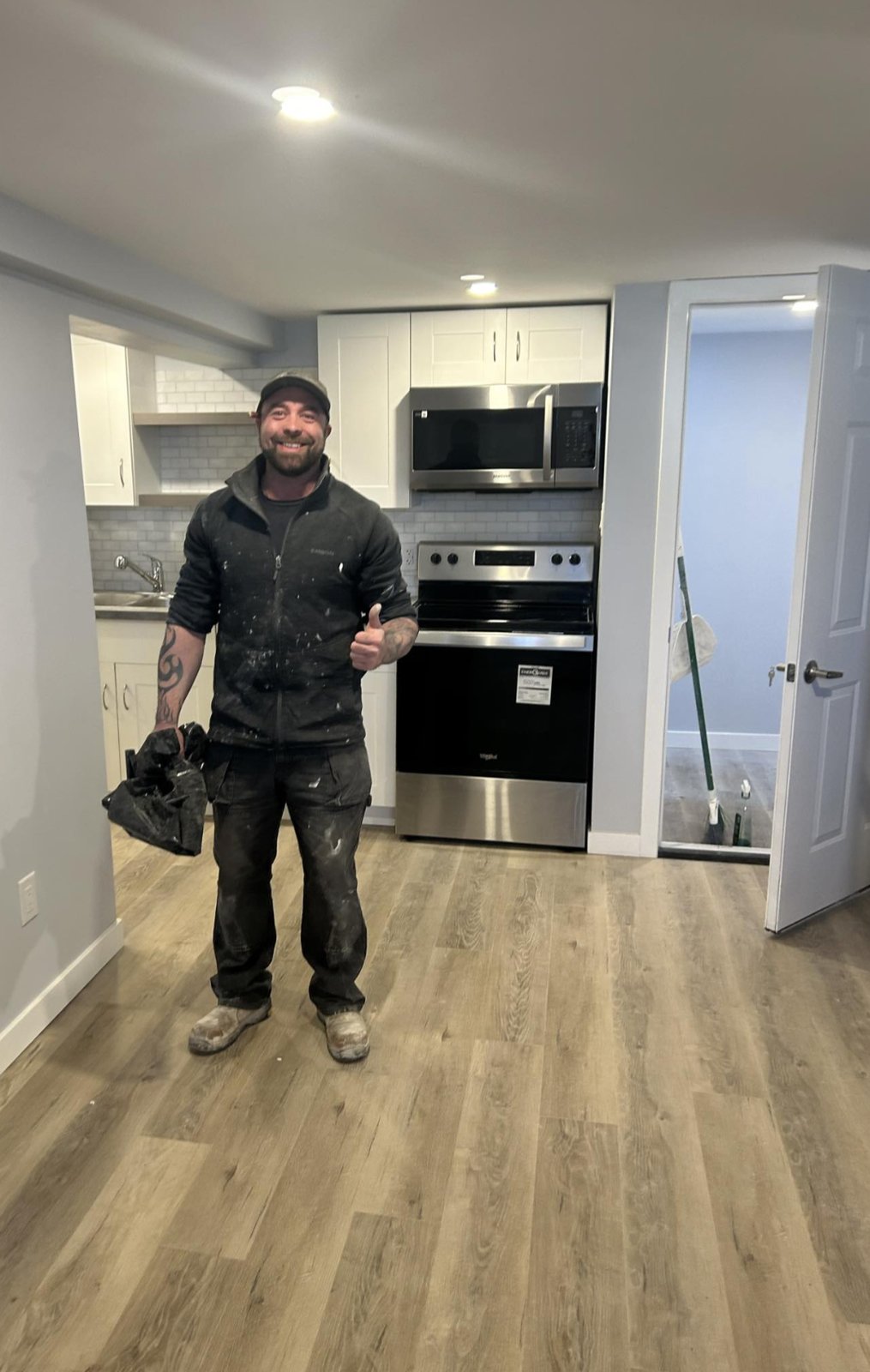 Finished basement suite with kitchenette and plank flooring by Valhalla Construction in Riverview, NB