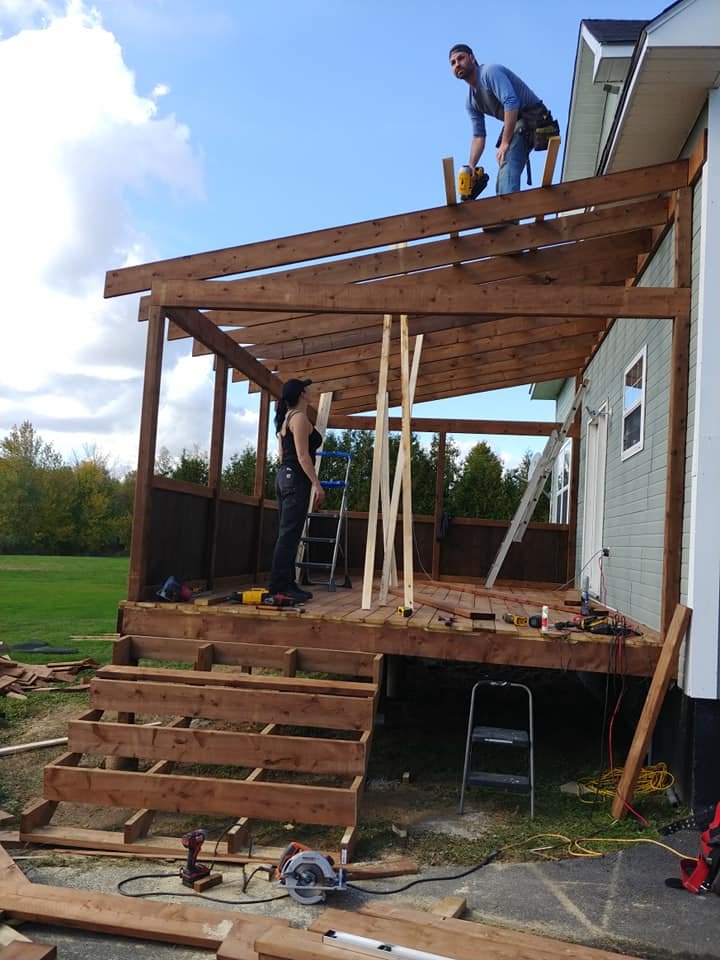 Roof structure being framed over an elevated deck