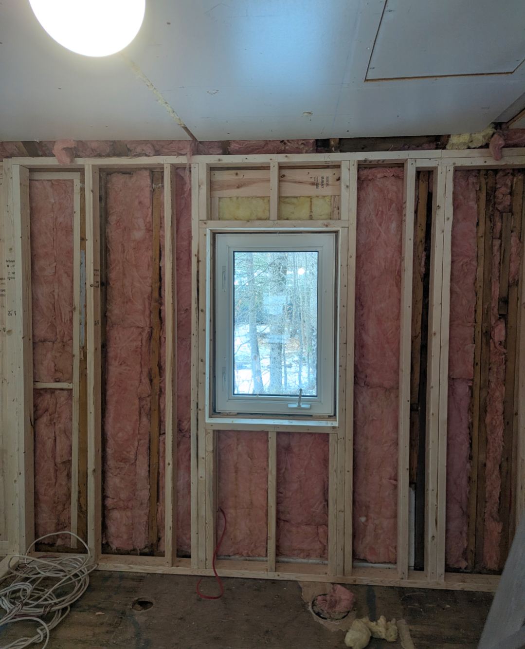New window framed and walls insulated during a bathroom remodel