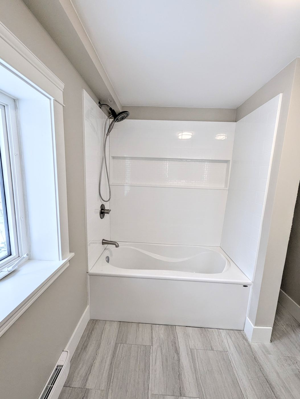 Finished tub and shower surround in a completed bathroom remodel