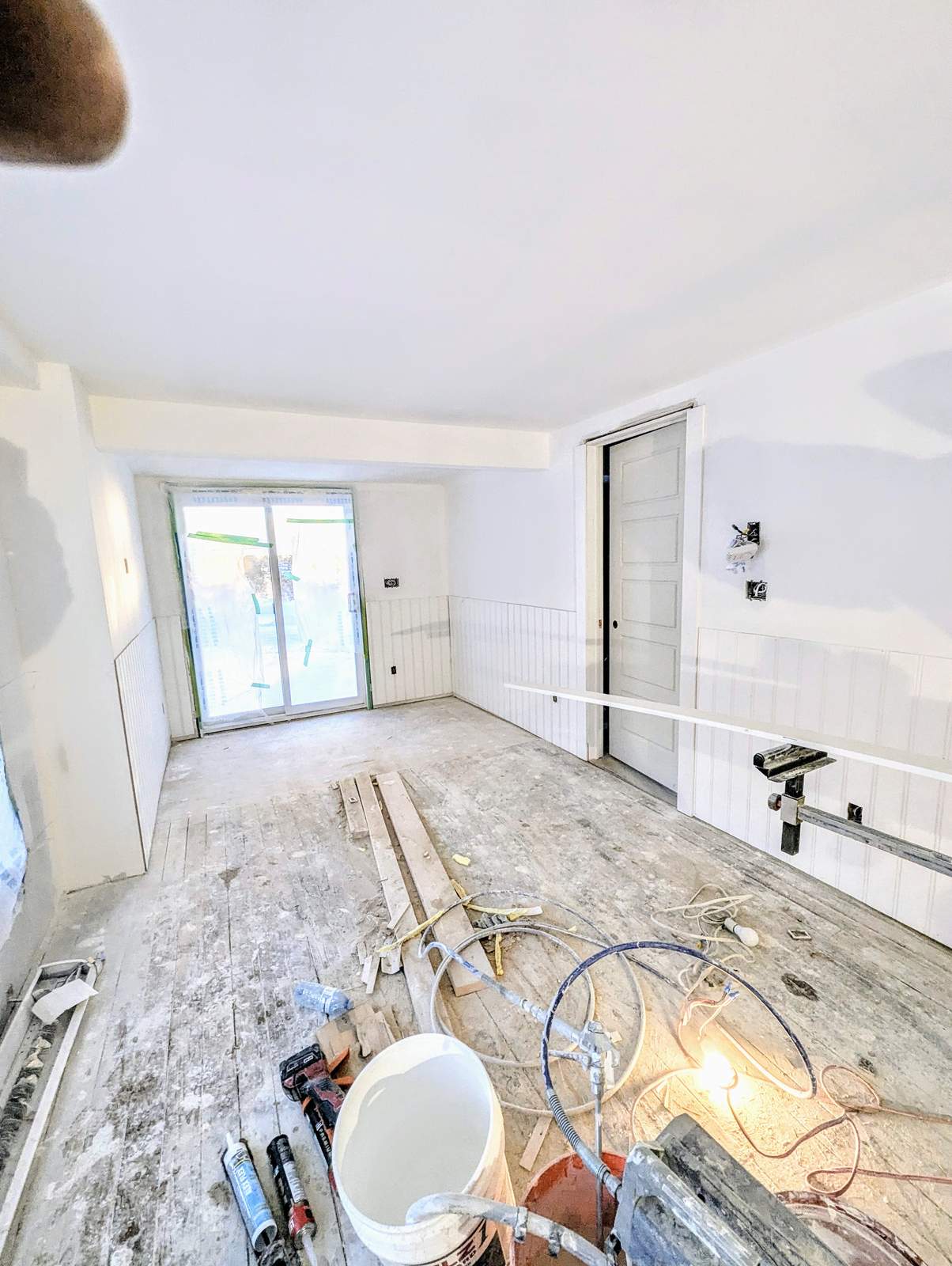 Living room subfloor prep before wainscoting and flooring installation