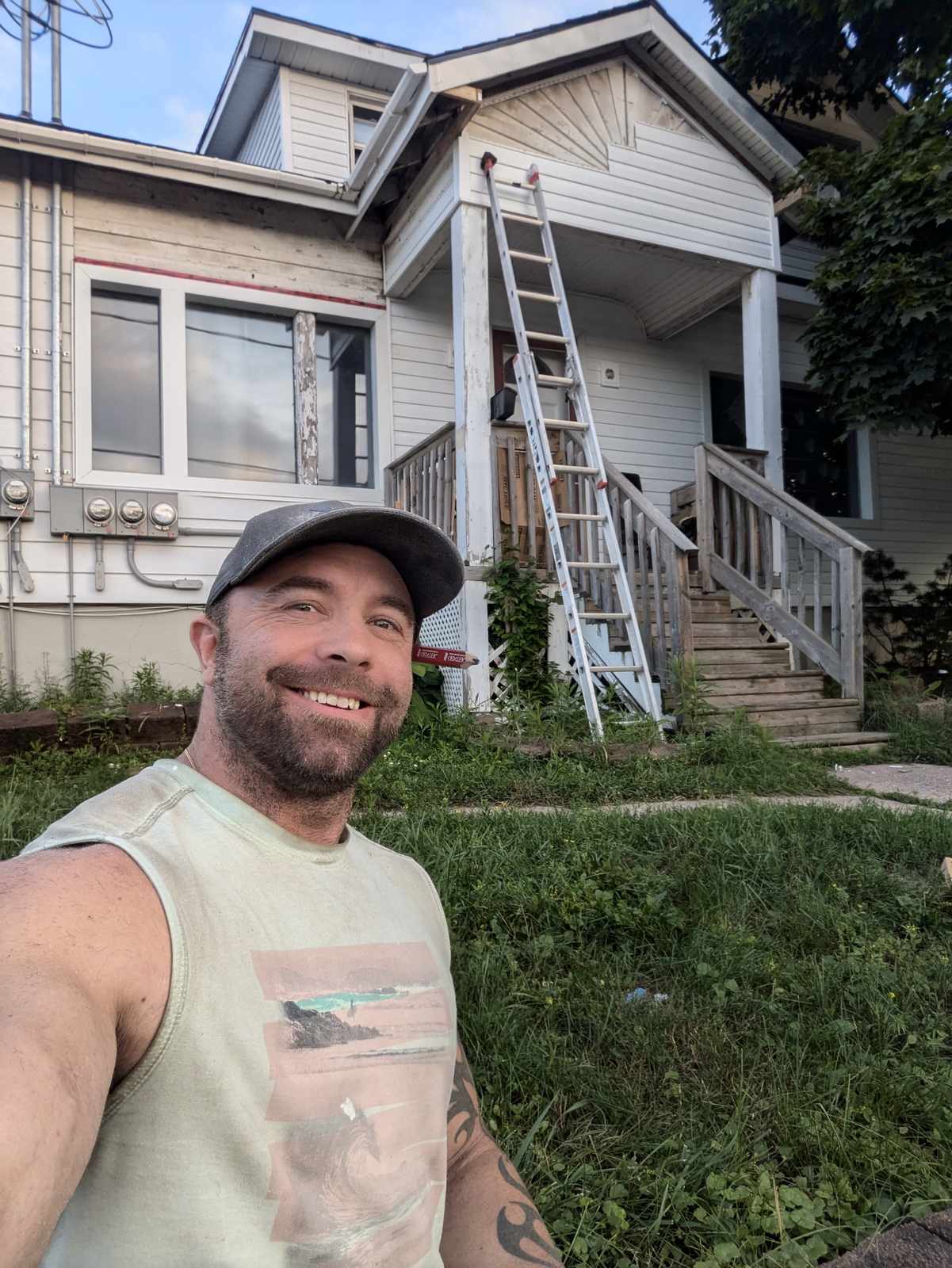 Valhalla Construction crew member in front of a finished siding renovation in Dieppe, NB