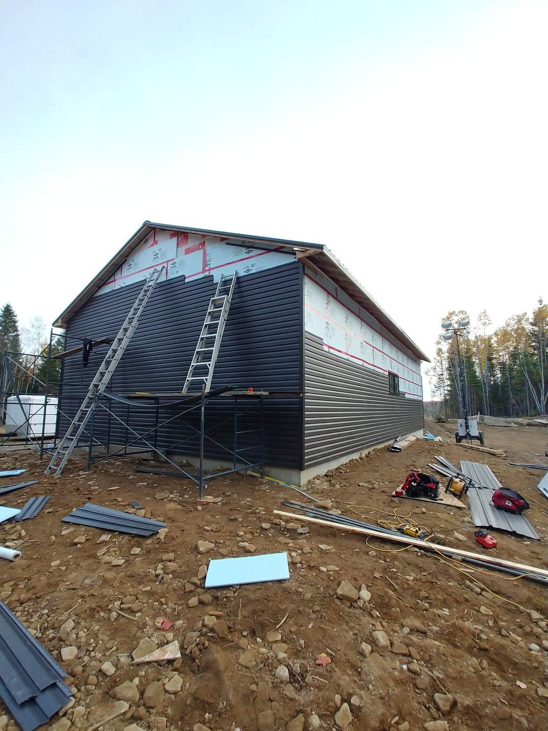 Custom garage with dark board-and-batten siding built by Valhalla Construction in Moncton, NB