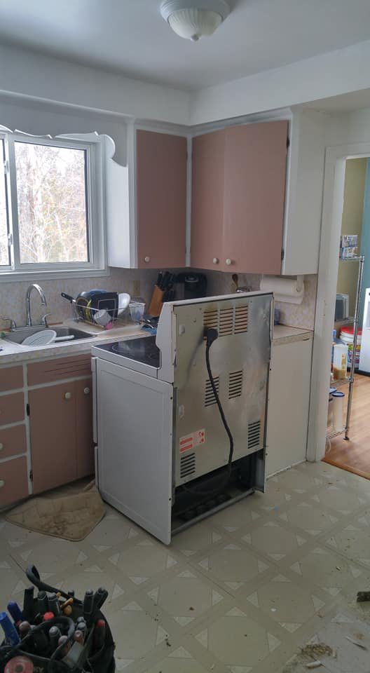 Dated pink kitchen cabinets and laminate counter before renovation