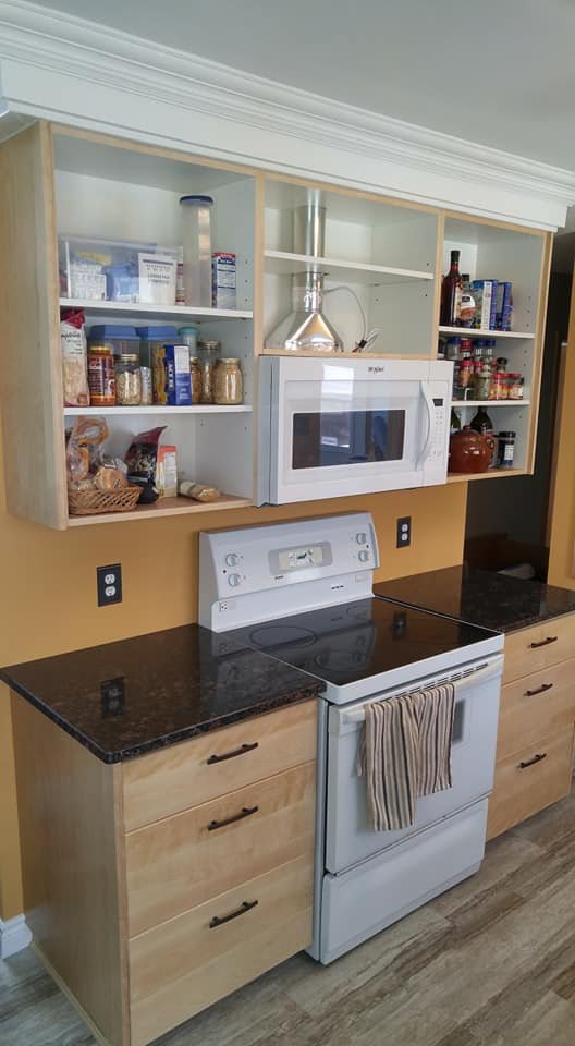 Finished kitchen renovation with hand-built honey oak cabinets, New Brunswick granite counters and open shelving by Valhalla Construction