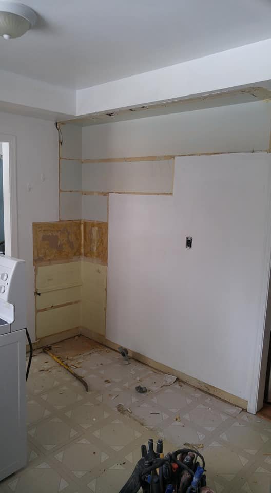 Kitchen wall stripped and header set after removing the wall to the dining area