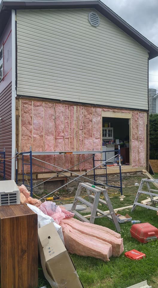 Close-up of rebuilt wall framing and insulation during repair