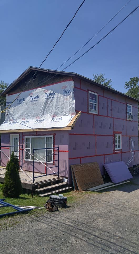 Wall opened up and wrapped during a structural siding repair