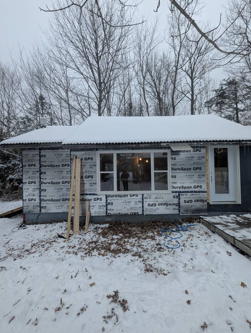 Front elevation covered in taped rigid foam insulation board before siding